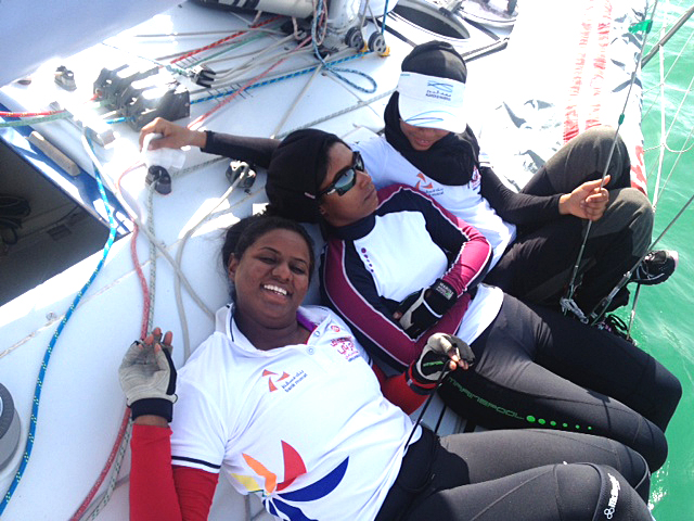 Girls hanging out on motor of boat